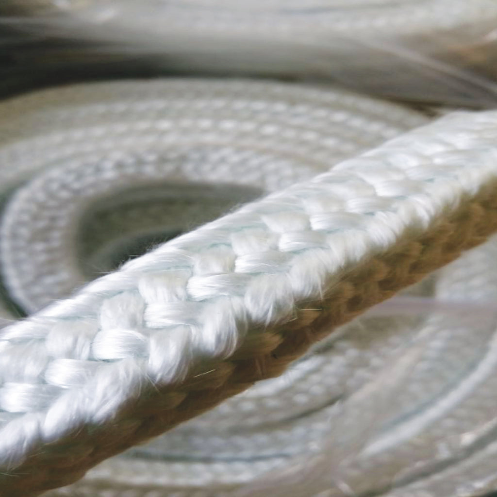 Coiled square braided ceramic fibre rope in white for high-temperature gasketing and sealing, displayed on a pale grey background