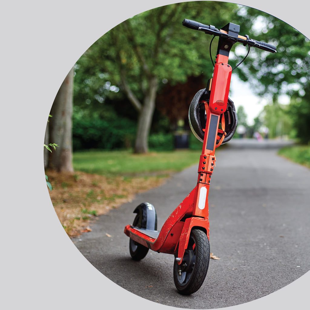 Electric scooter parked outdoors on a paved path, representing another application scenario for EV fire containment blankets.
