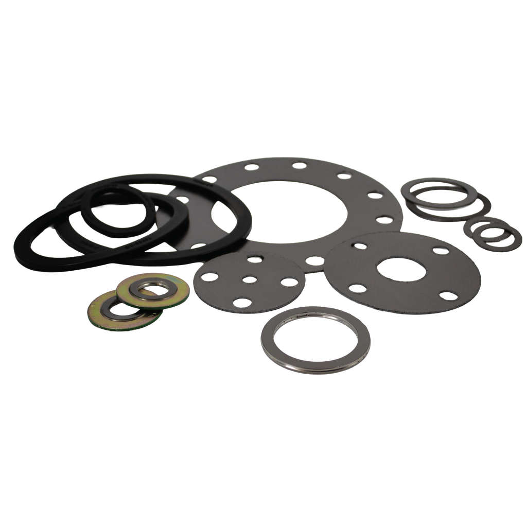 A collection of industrial gaskets including flat ring gaskets, spiral wound gaskets, and flanged gaskets in various sizes and materials, arranged on a light grey surface for boiler and compressor sealing applications.
