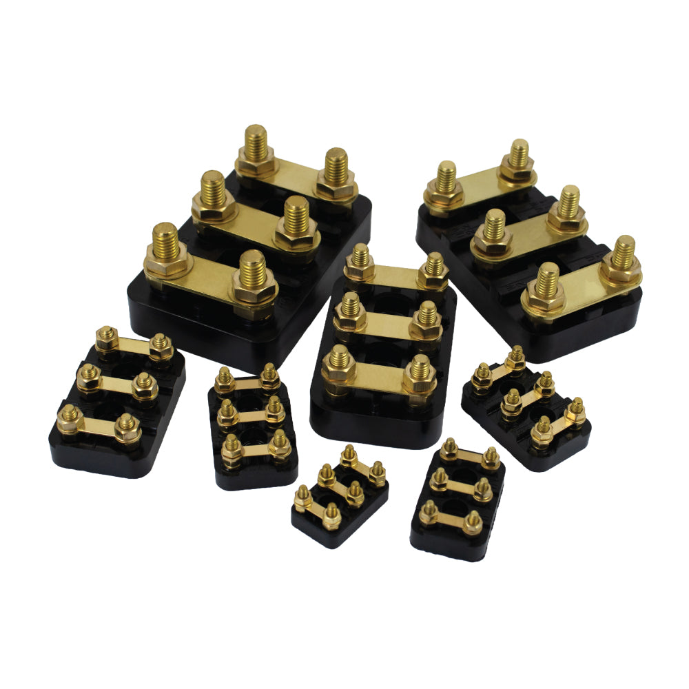 brass and black terminal blocks in assorted sizes for motor control panel wiring and electrical connections